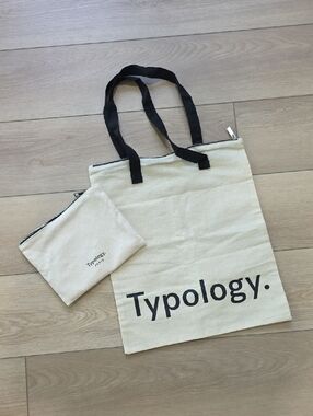Typology Canvas Tote Bag And Travel Pouch with Black Handles And Zipper Closure